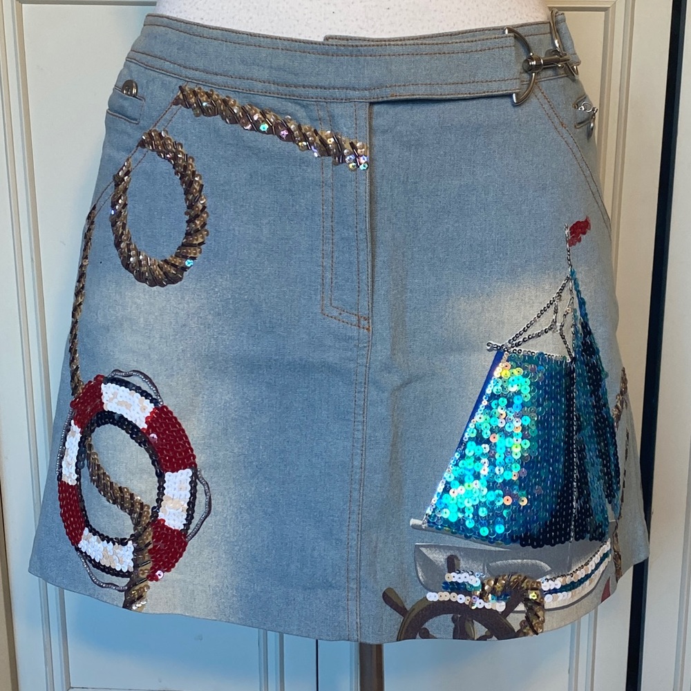 One of a kind denim mini skirt with sequin detail.